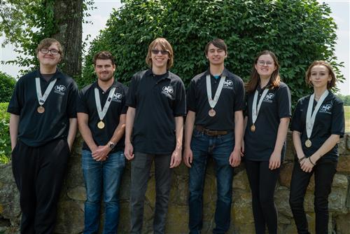 Students disp[lay their SkillsUSA medals. dressed in their black MMT shirts